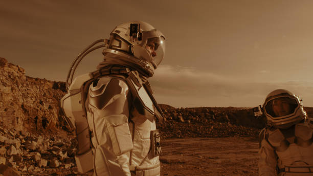 istock Male astronaut adjusting camera on colleague 1324679173