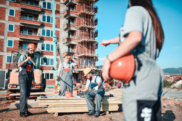 istock Female Civil Engineer Telling Workers On To Stop Break And Continue Working 1324679836