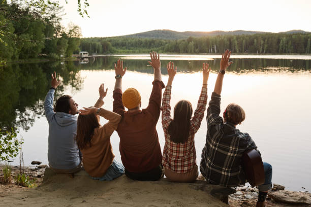 istock Happy friends sitting on the nature 1324681820