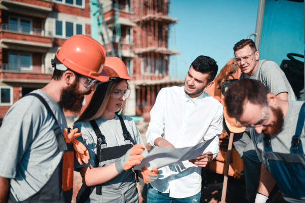istock Female Civil Engineer Consulting Architect About Building Procedure With Workers 1324681860
