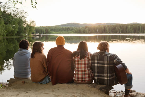 istock Friends sitting outdoors 1324682455