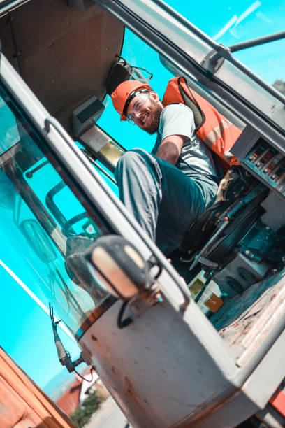 istock Male Bulldozer Driver Relaxing In Cockpit During Work Break 1324682457