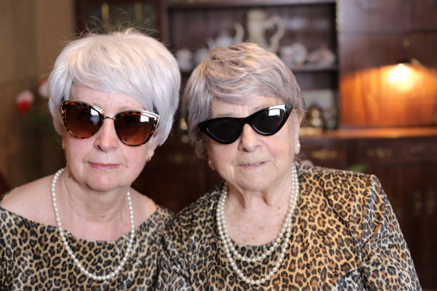 Senior sisters with matching leopard outfits stock photo