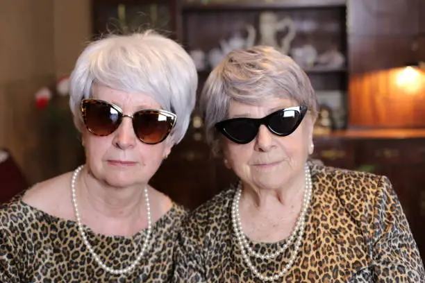 Senior sisters with matching leopard outfits.