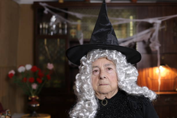 istock Senior witch with white curly hair 1324683604