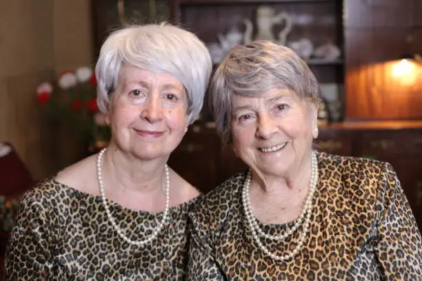 Senior sisters with matching leopard outfits.