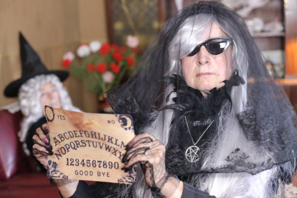Spooky lady holding ouija board