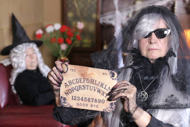 istock Spooky lady holding ouija board 1324683771