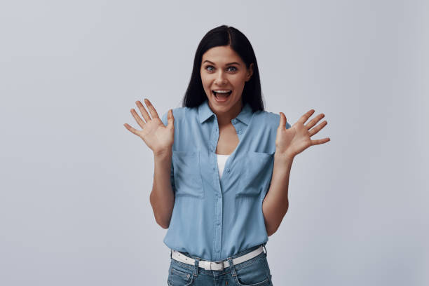 istock Surprised young woman looking at camera and gesturing 1324685263