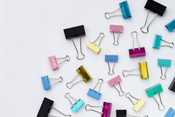 istock Colorful office paper clips on white background. 1324685995