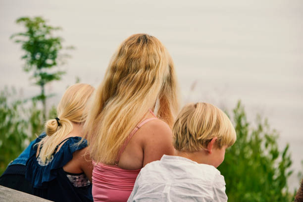 istock Mother and children on bench 1324686110