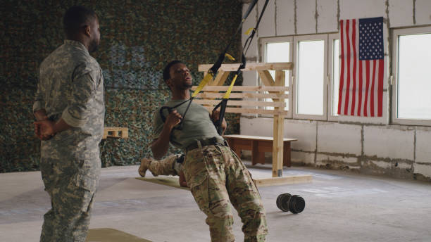 istock African American trainer instructing soldier during suspension training 1324687800