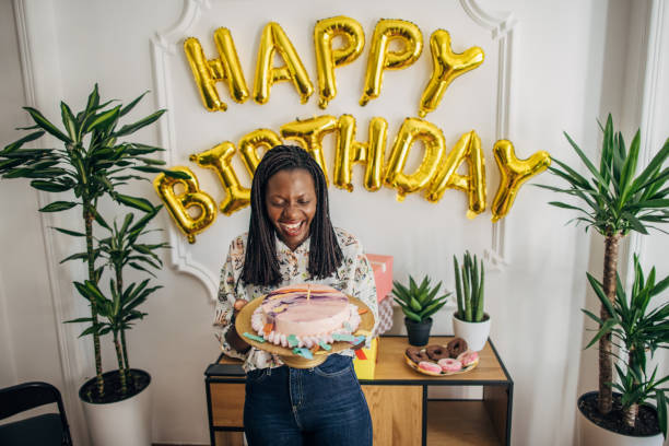 One woman, black female holding her birthday cake on her birthday party.