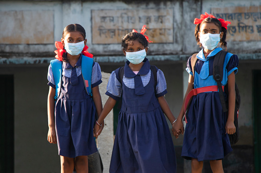indian village government school girls Wearing mask standing at school