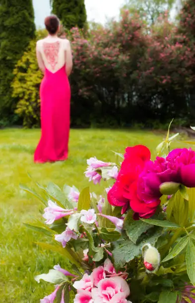 Photo of Bouquet of flowers in red tones and a girl