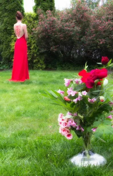 Photo of Bouquet of flowers in red tones and a girl