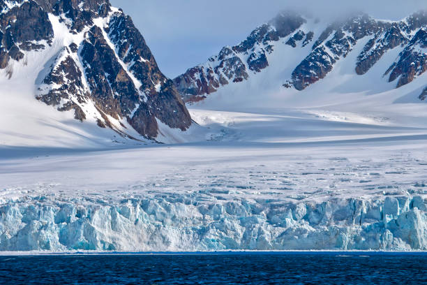 istock Deep Blue Glacier and Snowcapped Mountains, Arctic, Svalbard, Norway 1324691114