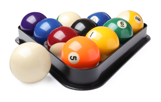 Plastic rack with billiard balls on white background