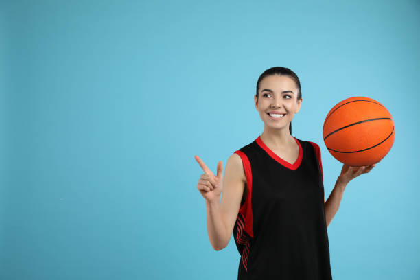 istock Basketball player with ball on light blue background. Space for text 1324692720