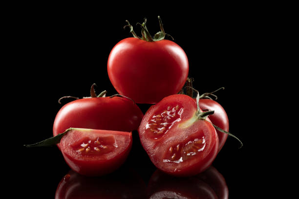 istock Red tomato with water drops on black 1324692796