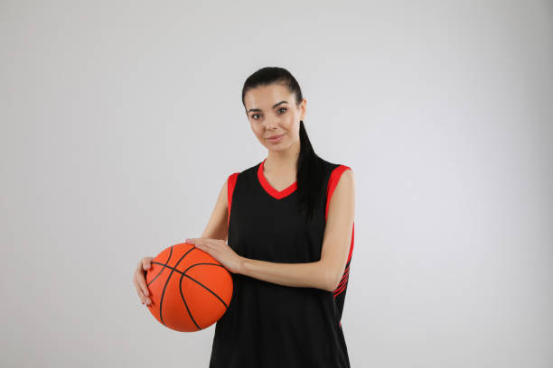 istock Basketball player with ball on grey background 1324692851
