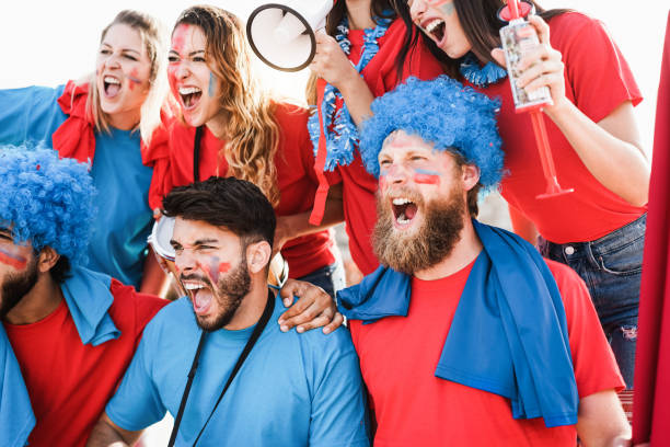 istock Crazy sport fans screaming while supporting their team - Focus on center man face 1324693002