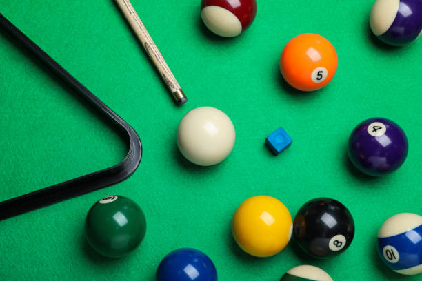 istock Flat lay composition with balls and cue on billiard table 1324693170