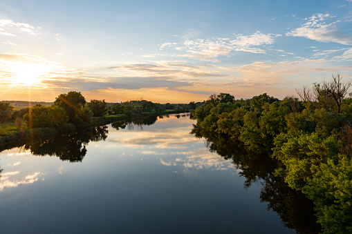 Shots of the Morava river in early summer with Slovakia on one side and Austria on the other. People were shot here during cold war times for trying to escape to the west.