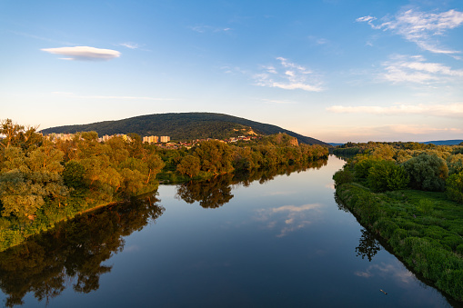 Shots of the Morava river in early summer with Slovakia on one side and Austria on the other. People were shot here during cold war times for trying to escape to the west.