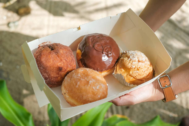 istock bakery in hand the backdrop of a beautiful beach 1324694130