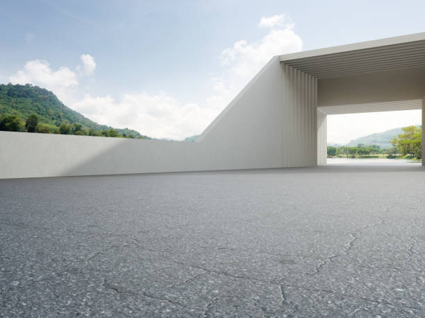 istock Abstract architecture design of modern building. Empty parking area floor and concrete wall with mountain and blue sky lake view. 1324695711