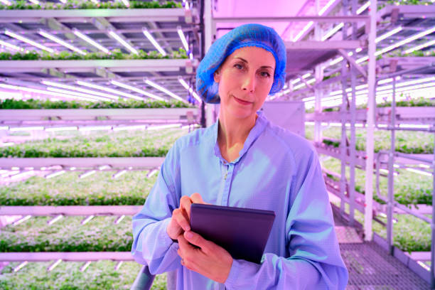 Candid portrait of chief gardener using digital tablet