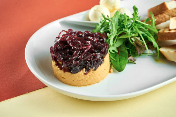 istock Turkey liver pate with onion confit, curtons in a white plate on bright colored backgrounds 1324696460