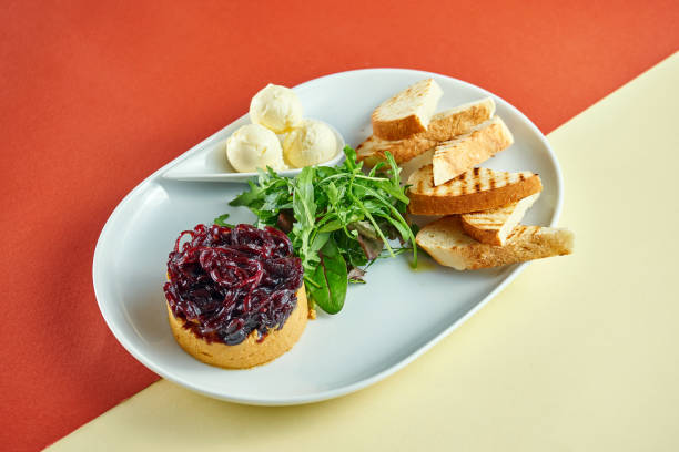 istock Turkey liver pate with onion confit, curtons in a white plate on bright colored backgrounds 1324696586