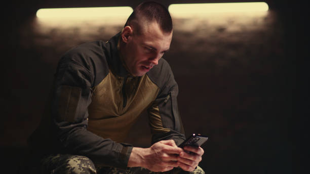 istock Military man making video call on smartphone 1324697860