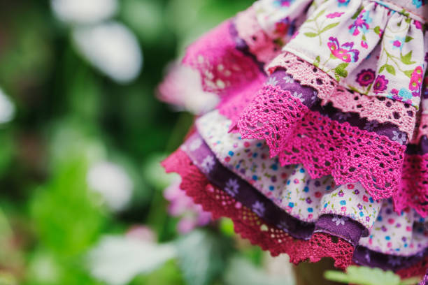 Beautiful layered dress close-up. Clothes in shades of fuchsia, purple and pink. Summer outfits made of cotton fabric.