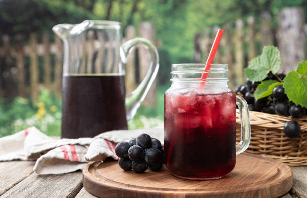 istock Glass of Grape Juice and Fresh Grapes 1324700193