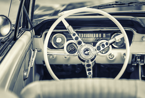 Hamburg, Germany - June 20. 2021:  Inside view of classic Ford Mustang, parked somewhere in Hamburg, Germany. Sepia toned image