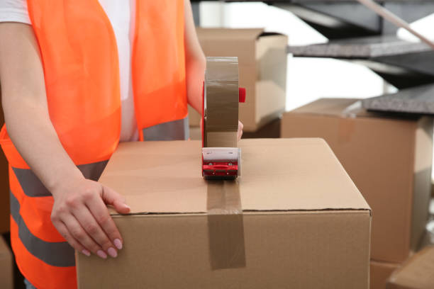 istock Worker taping cardboard box indoors, closeup view 1324700290