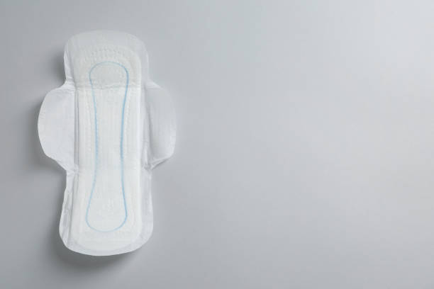 istock Sanitary napkin on light grey background, top view. Space for text 1324700701
