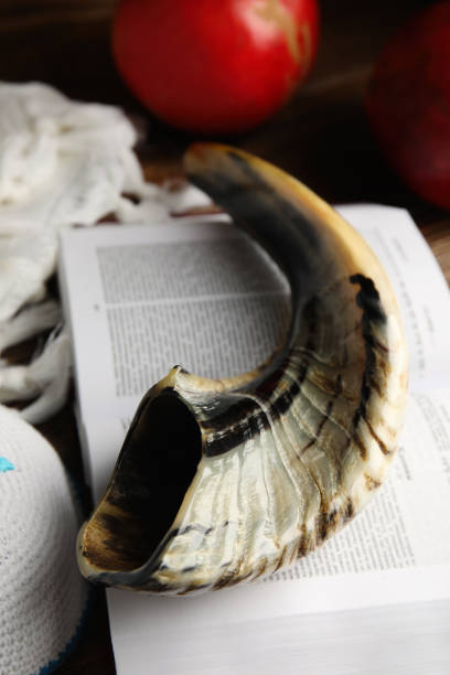 istock Shofar, kippah and open Torah on table, closeup. Rosh Hashanah celebration 1324700995