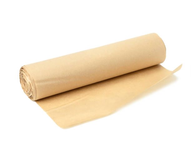 istock roll of brown parchment paper isolated on white background, for baking 1324701612