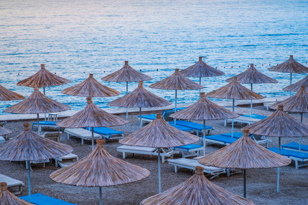 istock Beach thatched umbrellas on the beach promenade. 1324701697