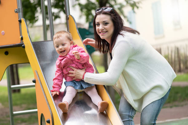 istock Baby girl having fun on a playground 1324702010
