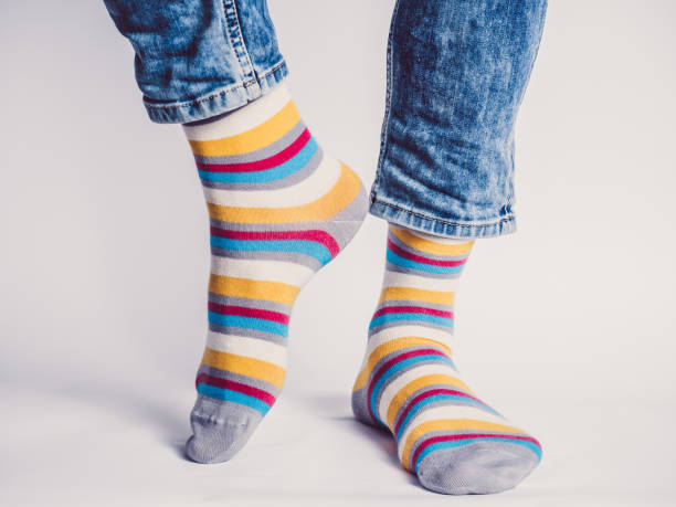 istock Men's legs and bright socks. Without shoes 1324702711