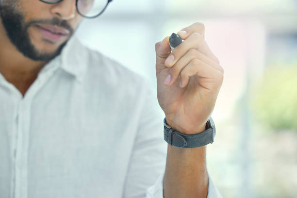 Cropped shot of an unrecognizable businessman working on a glass wipe board in his office It takes time to formulate a winning strategy transparent wipe board stock pictures, royalty-free photos & images