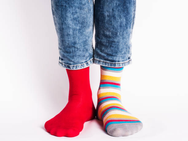istock Men's legs and bright socks. Without shoes 1324704000
