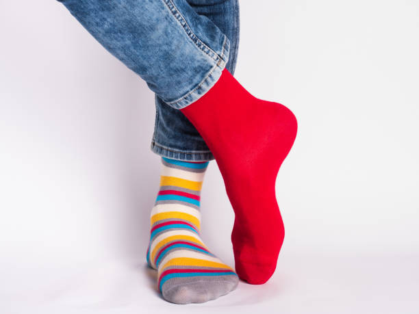istock Men's legs and bright socks. Without shoes 1324705077