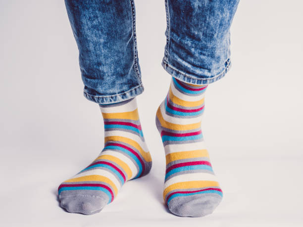 istock Men's legs and bright socks. Without shoes 1324705319
