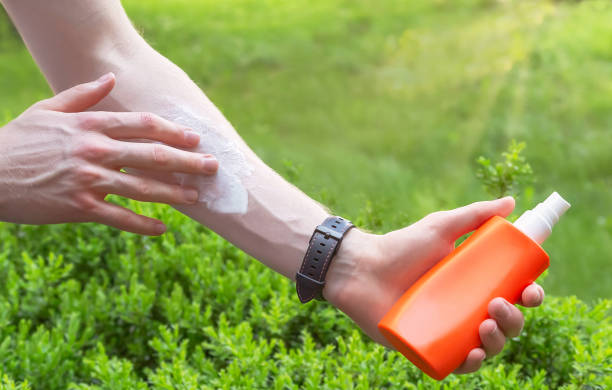 istock Hand of caucasian man applying sun cream from a plastic container. 1324706493